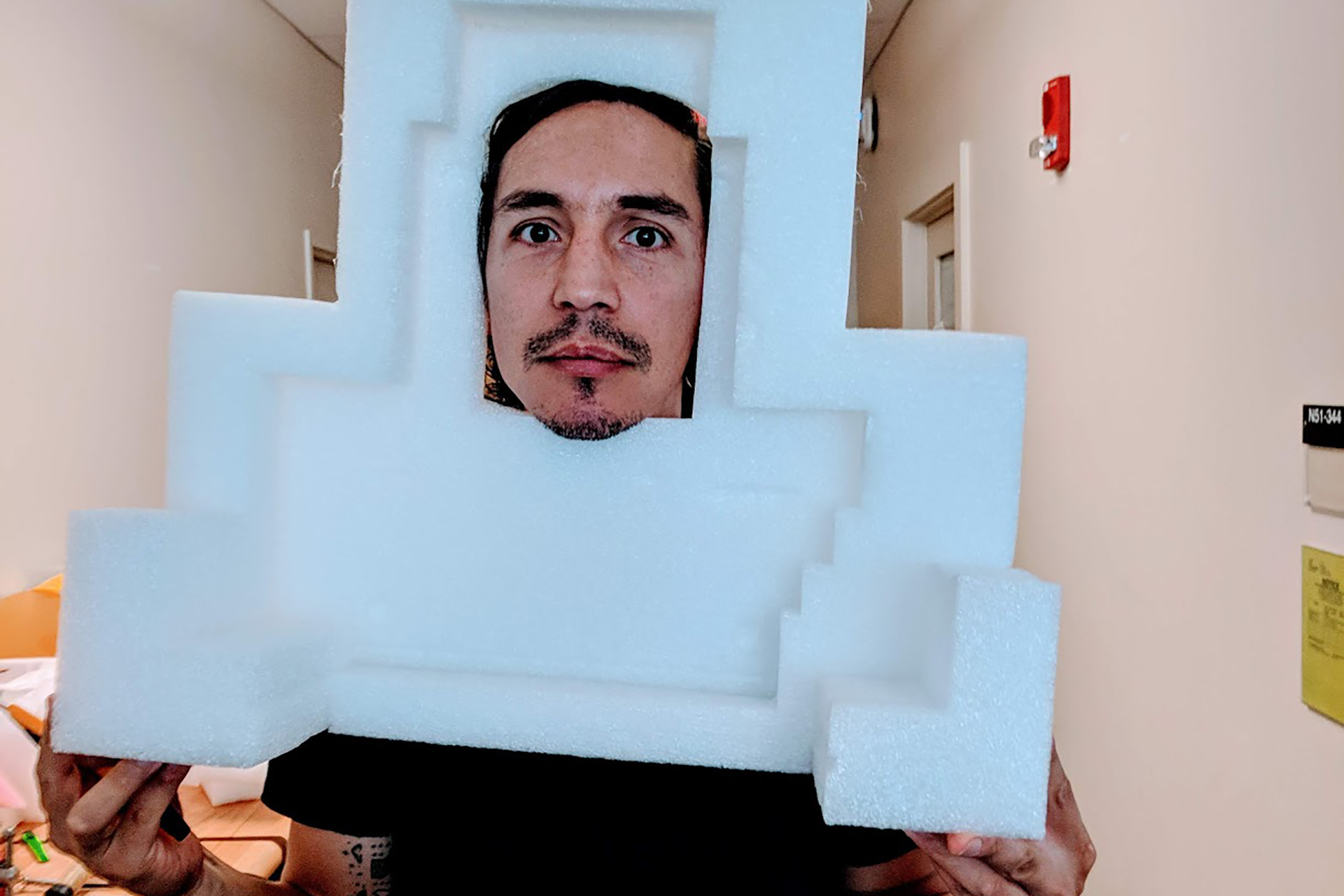 IDM student with their face peeking through a piece of styrofoam